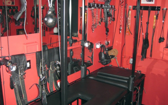 A red sex toy dungeon used for kinky bdsm acts with various sex toys