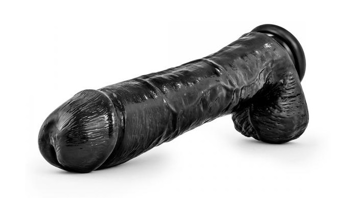 big black realistic dildo over white background