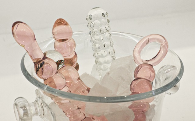 A variety of glass sex toys inserted into a bucket of ice