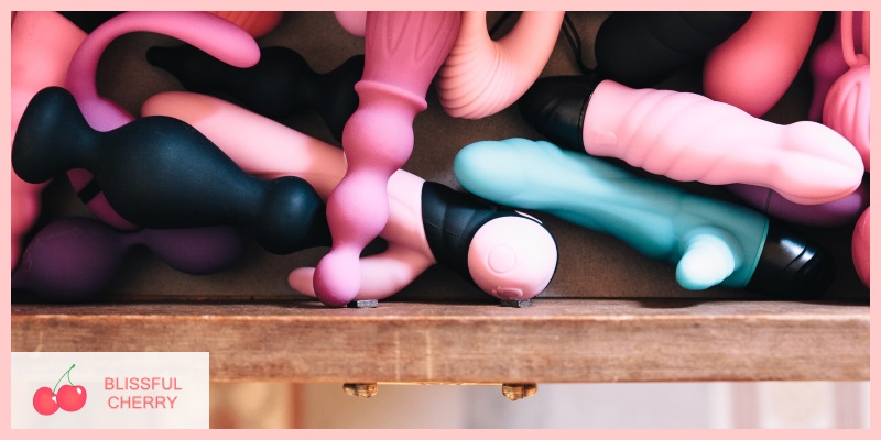 Various sex toys tucked away in a drawer