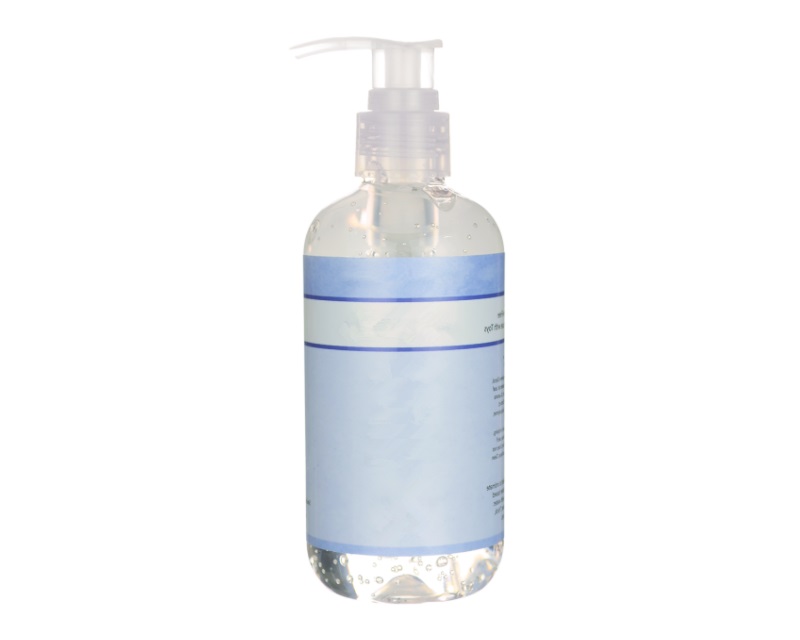 Clear bottle of silicone-based lube with white background