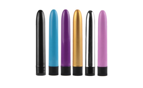 six plastic vibrators of various colors over white background