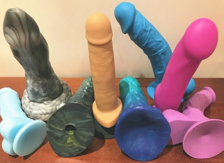 dildos of various shapes and colors on a table